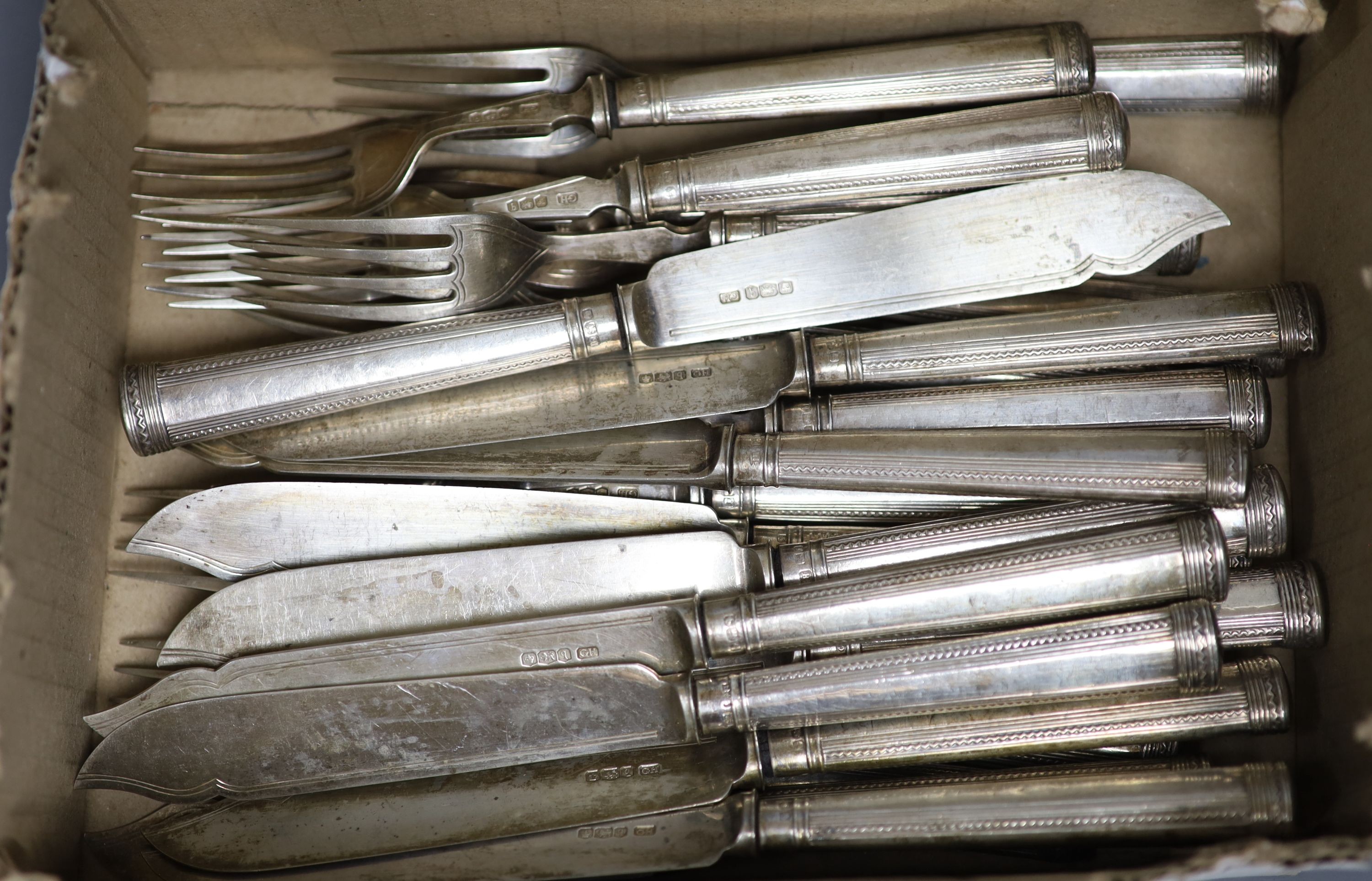 Twelve George V silver fish forks and eleven matching fish knives, George Howson, Sheffield, 1933, loaded handles.